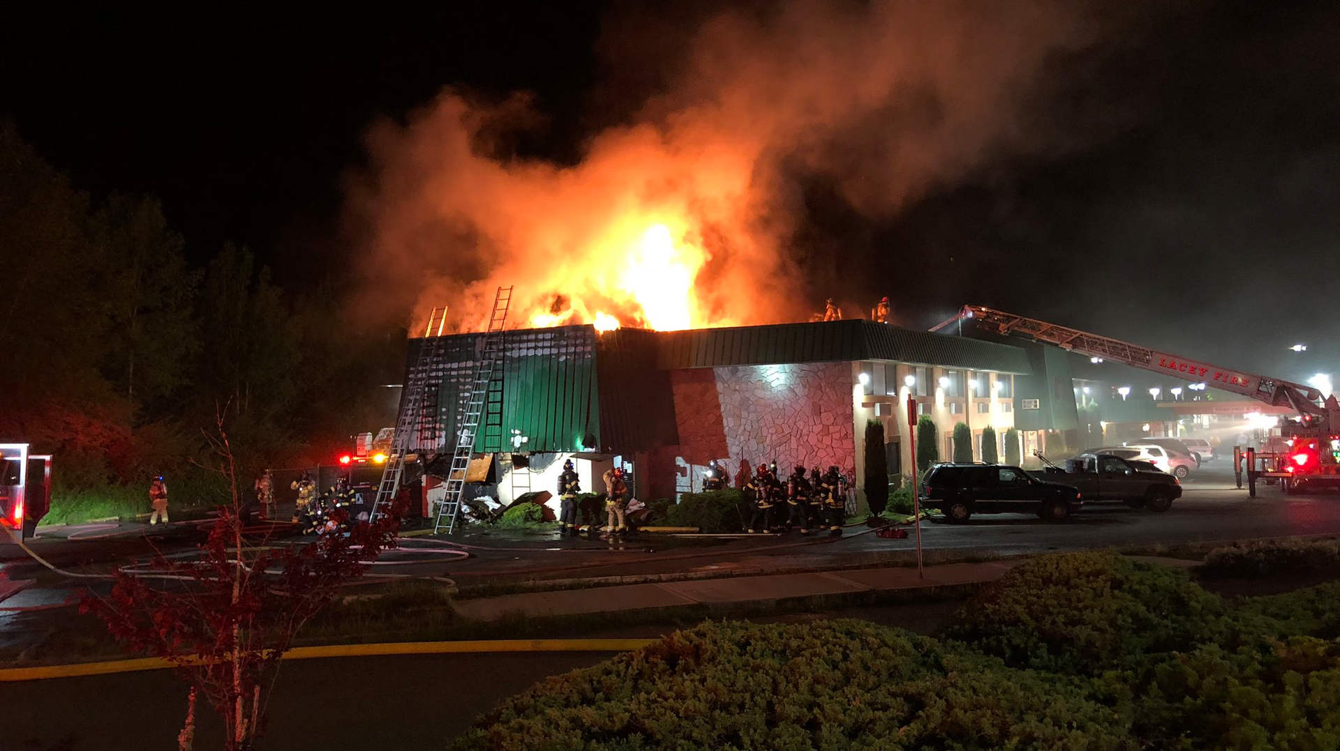 Crews from Olympia, WA, and five other departments battled a two-alarm blaze at a Quality Inn that was started by a burning shrub Thursday.