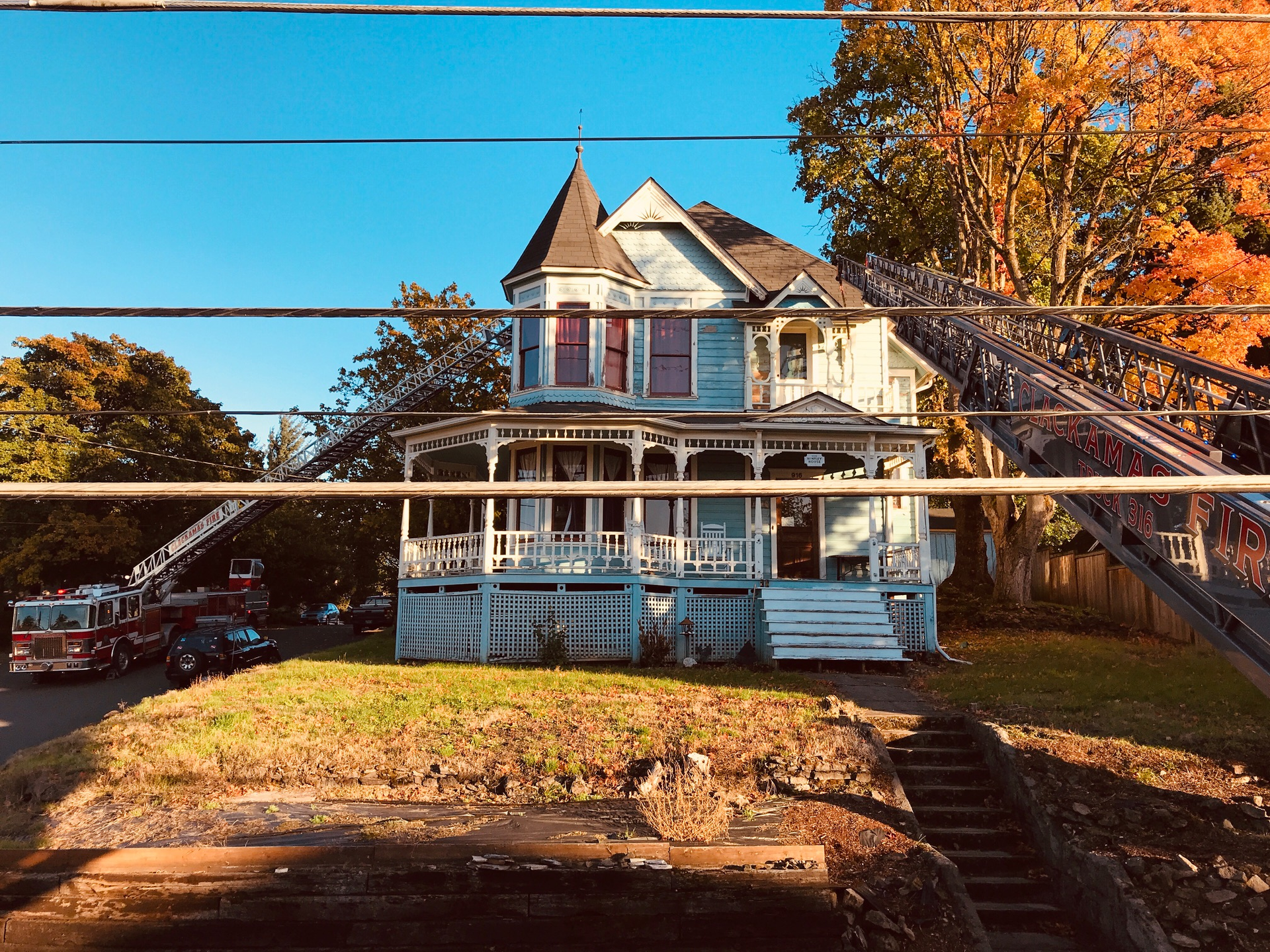 At a West Coast Offense class in Clackamas, OR, the first- and second-due trucks took their respective &ldquo;spots&rdquo; on this Victorian house, which was situated slightly on a hill. The scenario was described to them as follows: They arrived to find fire showing from the second-floor turret windows (the red star). First due took their position and then the second. Because of low-hanging data wires along the front of the house, first due took the inside spot and threw under the wires to reach the roof. The second took a position along the A/B corner, thus covering both sides of the fire. This was a great job by these operators, getting two solid spots that covered both sides of the involved area, one ladder company augmenting the other.