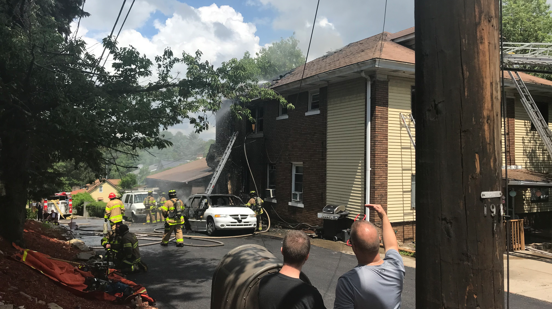 A Pittsburgh firefighter was injured battling a blaze that began in a vehicle and spread to a duplex Monday.