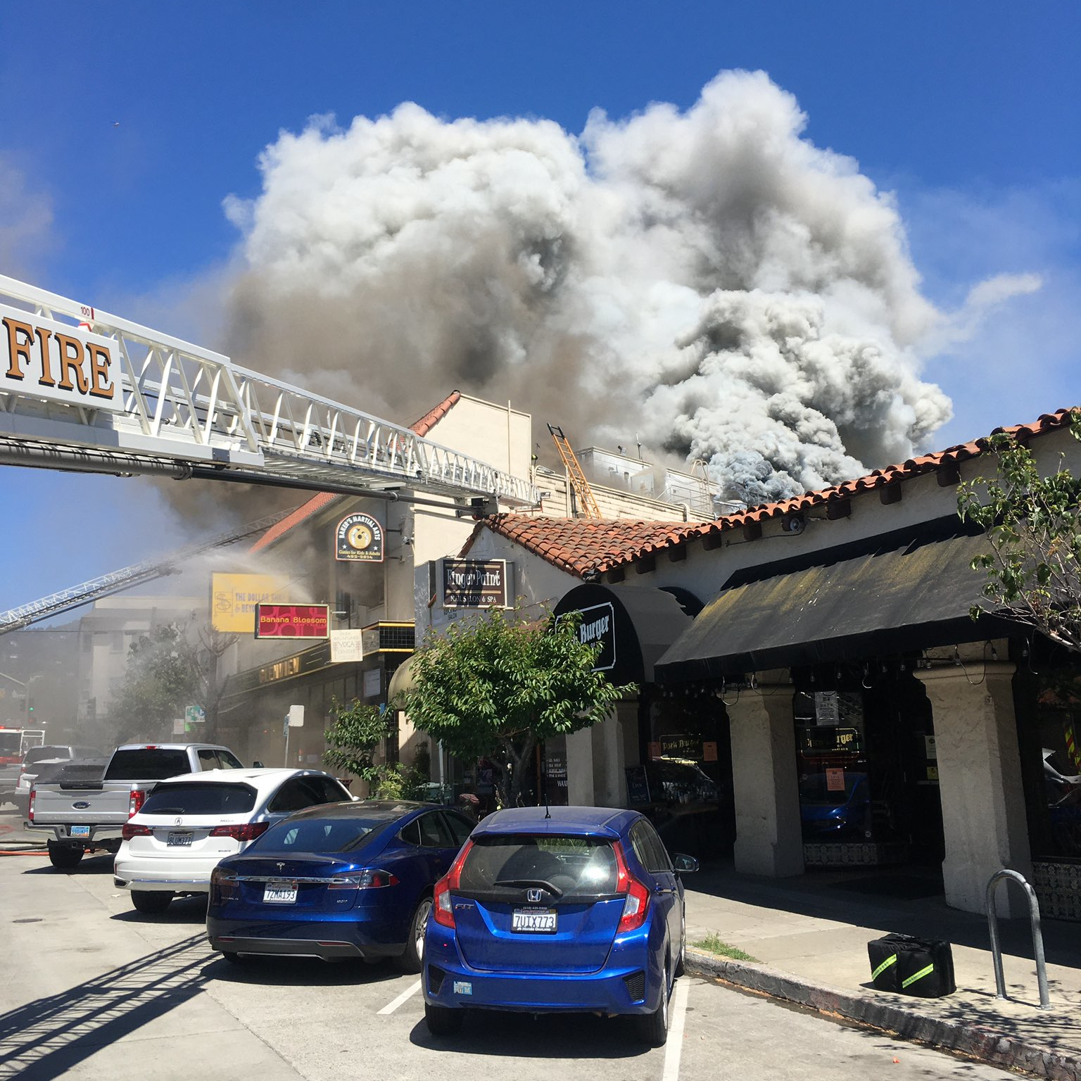 Oakland, CA, firefighters rescued two workers from the roof of a three-alarm blaze that broke out at a commercial building in the city's Glenview neighborhood Monday.