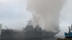 A firefighting helicopter flies in Monday to drop water on a U.S. Navy ship still burning in San Diego. A firefighting helicopter flies in Monday to drop water on a U.S. Navy ship still burning in San Diego.
