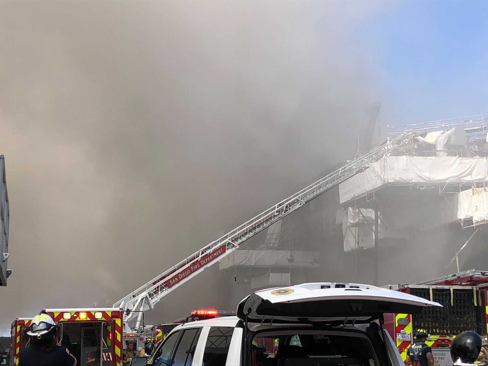 Firefighters from Federal Fire and San Diego Fire-Rescue are working at the scene of the three-alarm fire on the USS Bonhomme Richard.