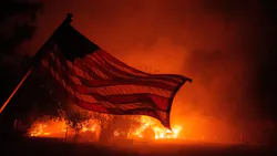 An American flag blows in the wind in front of a burning home in Vacaville, CA, as the LNU Lightning Complex fire burns in the background on Aug. 19, 2020. An American flag blows in the wind in front of a burning home in Vacaville, CA, as the LNU Lightning Complex fire burns in the background on Aug. 19, 2020.