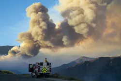 A firefighter from Carpinteria monitors a huge plume of smoke from the Apple Fire along Bluff Street, north of Banning, CA, on Sunday, Aug. 2, 2020. A firefighter from Carpinteria monitors a huge plume of smoke from the Apple Fire along Bluff Street, north of Banning, CA, on Sunday, Aug. 2, 2020.