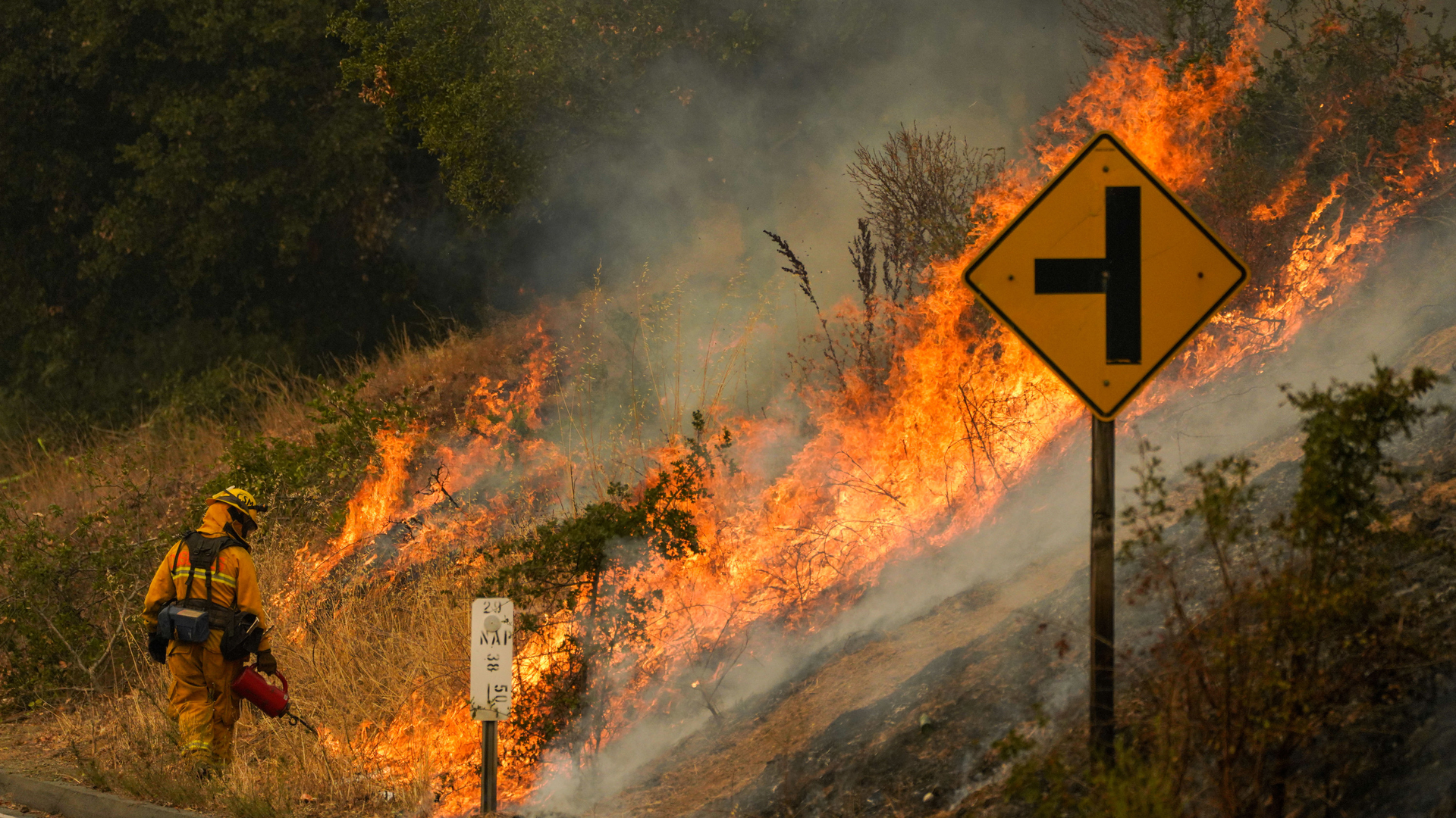A firefighter uses a drip torch during a backfire operation Sept. 29 during the Glass Fire along Silverado Trail in Calistoga, CA.