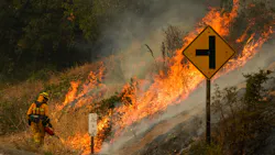A firefighter uses a drip torch during a backfire operation Sept. 29 during the Glass Fire along Silverado Trail in Calistoga, CA. A firefighter uses a drip torch during a backfire operation Sept. 29 during the Glass Fire along Silverado Trail in Calistoga, CA.
