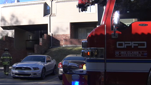 Overland Park, KS, firefighters forced their way inside a burning second-floor apartment Tuesday to rescue two unconscious boys, one who was rushed to the hospital in critical condition.