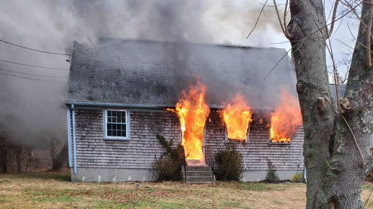 Dartmouth, MA, Fire District 2 firefighters rescued an unconscious woman from a burning two-story home Monday.