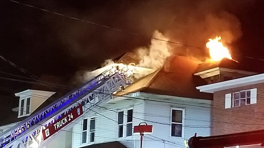 A firefighter collapsed on the roof of a burning house in Greensburg, PA, as crews worked to put out the residential fire early Friday.