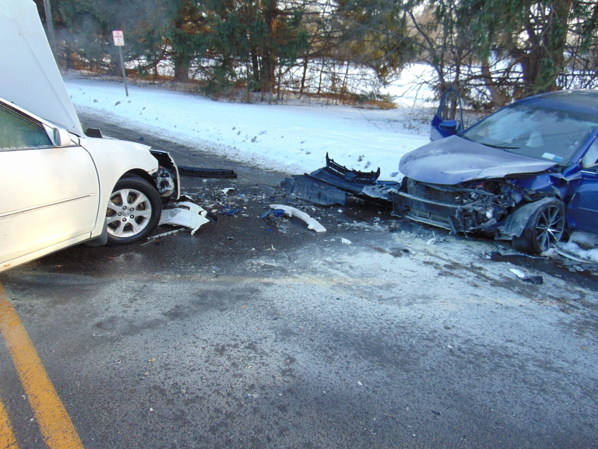 A New York Mills, NY, Fire Department captain, a police officer and a civilian saved a woman from her burning vehicle following a head-on collision Monday.