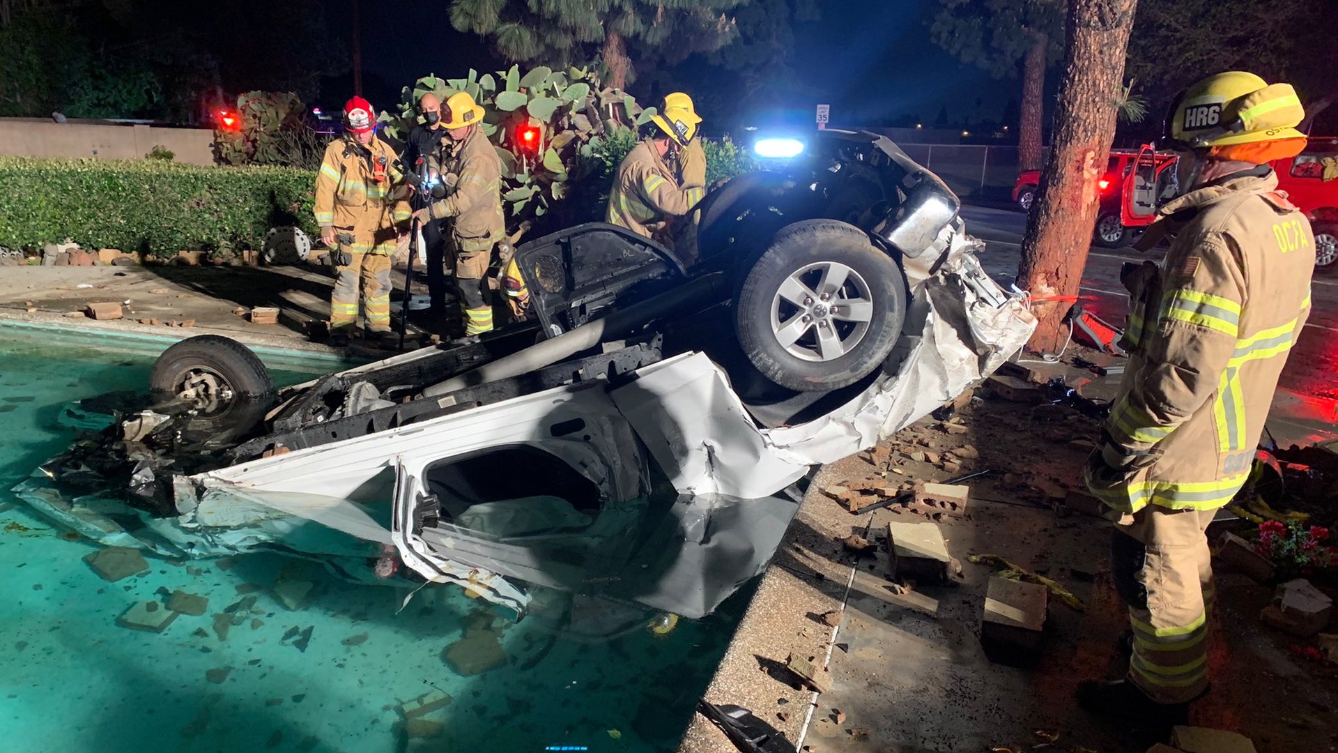 Orange County firefighters at the scene a crash between a pickup and car that left three dead.