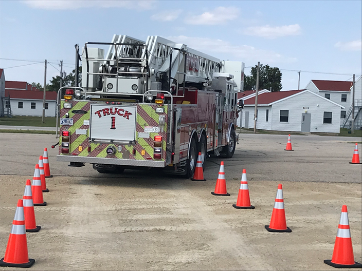 Practicing essential driving tasks on a cone driving course, such as the driver of this aerial apparatus attempting the alley dock exercise, gives drivers the opportunity to feel the forces that act on a vehicle without being on public streets.