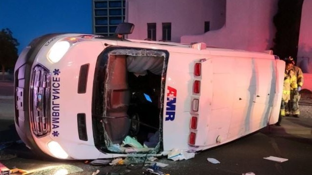 Two American Medical Response EMTs were injured when their ambulance rolled over after it was struck by an alleged drunk driver who ran a stop sign in Las Cruces, NM, on Thursday.