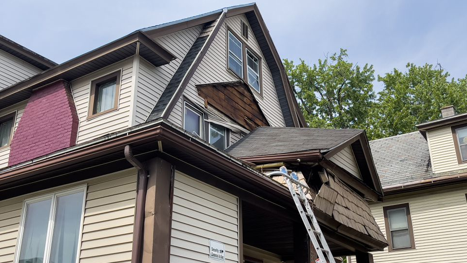 Springfield, MA, firefighters rescued a worker who was trapped under debris from the collapse of a second-story porch roof Wednesday.
