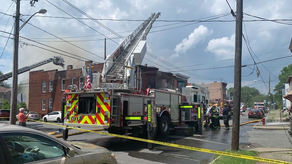 Firefighters from departments around the area had to contend with brutal heat and humidity as they battled a fire that tore through three row houses in Watervliet, NY, on Monday.