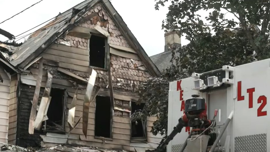 Two firefighters were injured battling a five-alarm fire that tore through three homes in Kearny, NJ, on Sunday.