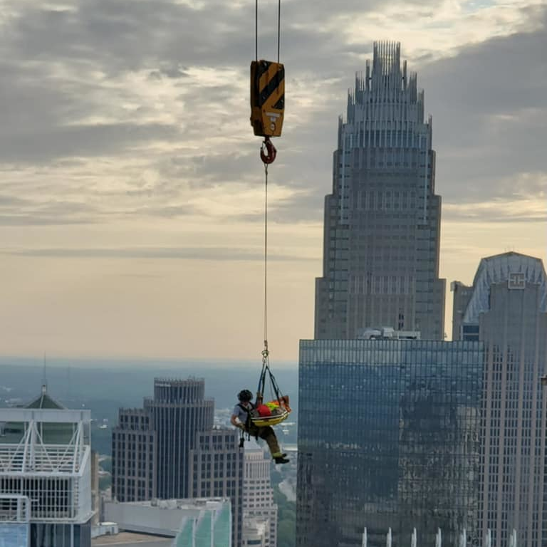 A Charlotte, NC, firefighter rescues a construction worker who was injured on the 40th floor of a skyscraper Thursday.