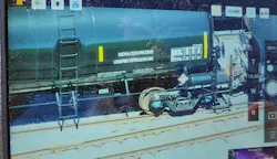 This photograph of a rail car was captured by a drone from one-half mile away. Such capability permits identification of products in rail cars and highway transportation vehicles without putting personnel in harm’s way. This photograph of a rail car was captured by a drone from one-half mile away. Such capability permits identification of products in rail cars and highway transportation vehicles without putting personnel in harm’s way.