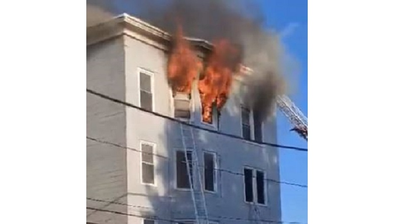 A fire burns on the sixth floor of an apartment building in Lewiston, ME, where a 70-year-old man leaped to escape the flames and died on Sept. 11, 2021.
