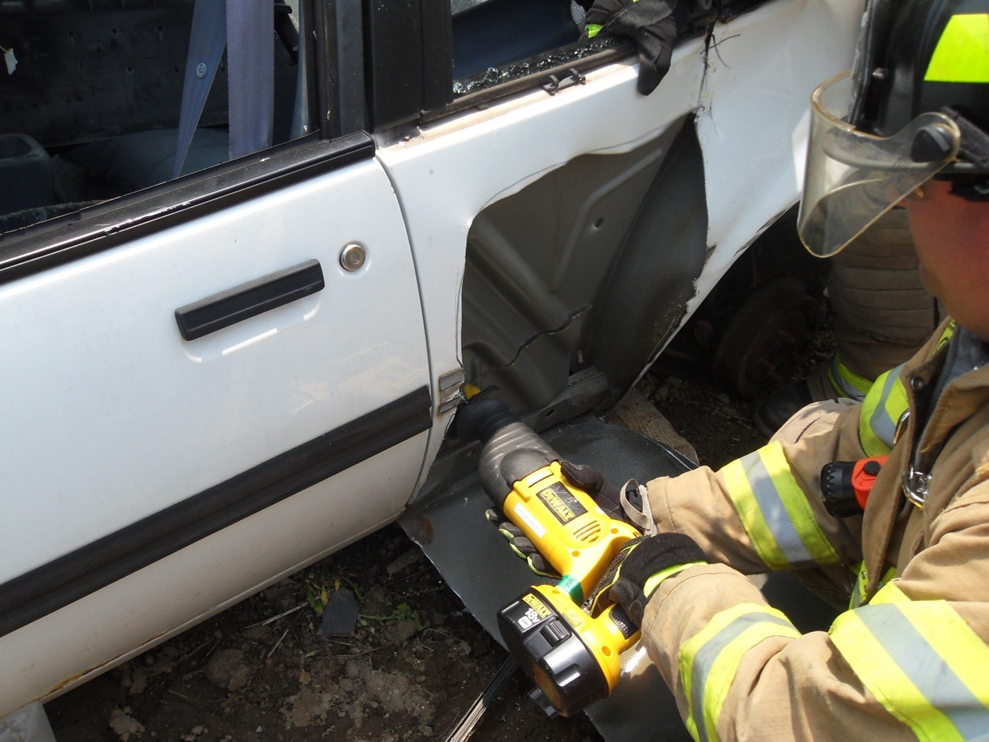 Photo 3: For the third-door-full-removal procedure, after &ldquo;skinning&rdquo; the rear panel of the vehicle to produce better visibility of the area to be cut and removed, use a reciprocating saw to cut the panel along the outline of the rear seat. A good blade can make the difference in the operation of a reciprocating saw.