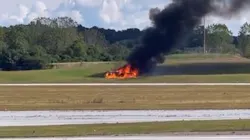 A small plane burns after crashing in a field next to a runway at DeKalb-Peachtree airport in Chamblee, GA, on Friday Oct. 8, 2021. A small plane burns after crashing in a field next to a runway at DeKalb-Peachtree airport in Chamblee, GA, on Friday Oct. 8, 2021.