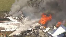 Firefighters douse a burning plane with foam following a crash near Houston Executive Airport on Tuesday, Oct. 19, 2021. Firefighters douse a burning plane with foam following a crash near Houston Executive Airport on Tuesday, Oct. 19, 2021.