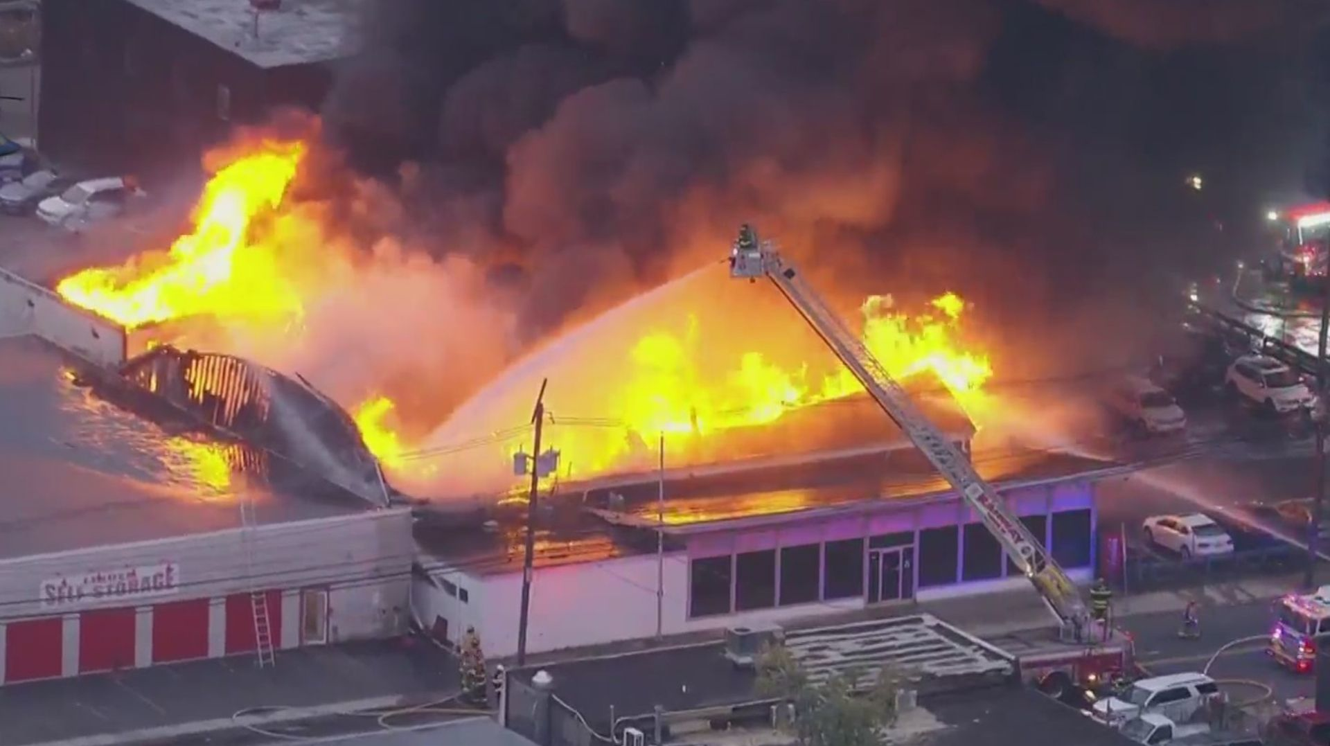 A Volkswagen dealership burns in a massive multi-alarm fire in Linden, NJ, on Friday, Oct. 29, 2021.