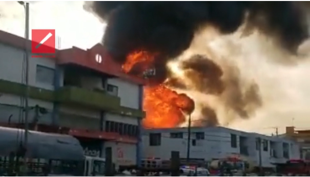 Fire engulfs a business in La Vega Wednesday that left three firefighters dead and several injured.