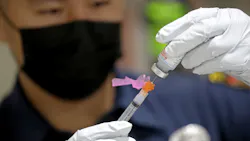 An LAFD paramedic prepares a dose of the Moderna COVID-19 vaccine for a firefighter in December 2020. An LAFD paramedic prepares a dose of the Moderna COVID-19 vaccine for a firefighter in December 2020.