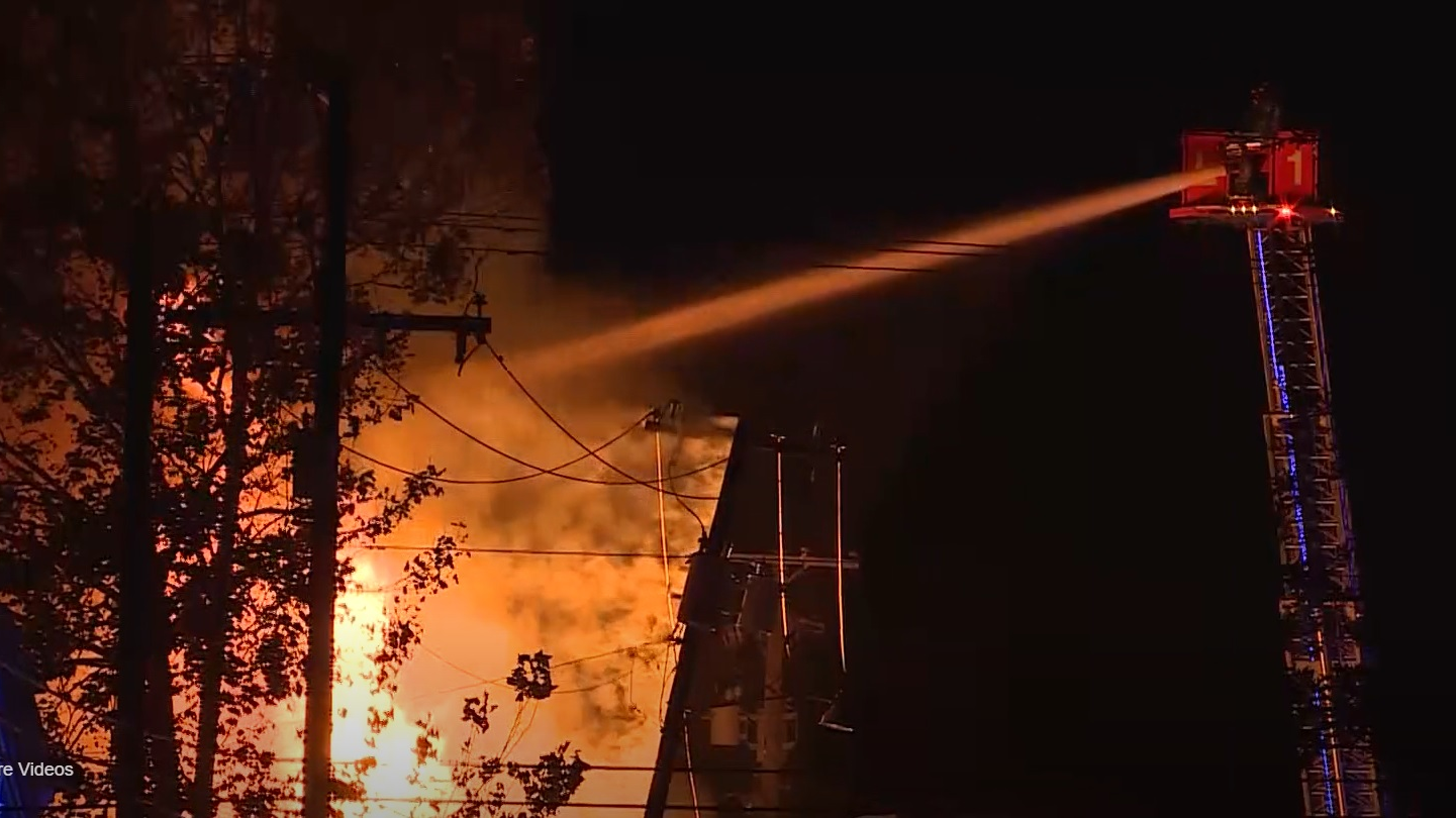 Firefighters use an aerial master stream to control a downtown Covington, LA, fire.