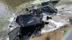 The shell of a burned-out semi-truck sits in a canal in Boynton Beach, FL, after crashing and catching fire on Wednesday, Nov. 17, 2021. The shell of a burned-out semi-truck sits in a canal in Boynton Beach, FL, after crashing and catching fire on Wednesday, Nov. 17, 2021.