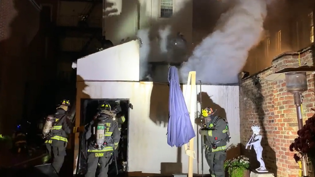 Firefighters work to control a fire adjacent to a DC historical landmark on Nov. 23, 2021.