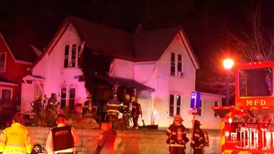 Firefighters on scene after dousing a duplex fire that critically injured a man in Minneapolis on Monday, Nov. 8, 2021.