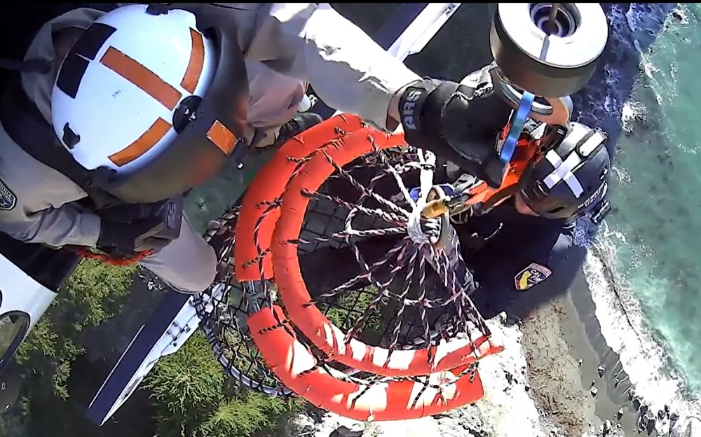 Rescuers use a Billy Pugh basket to extract the stranded hiker.