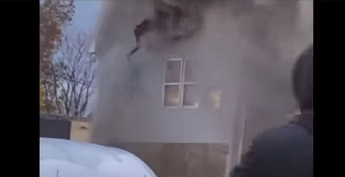 Heavy smoke and fire force a woman to jump from a second story window on Nov. 26, 2021