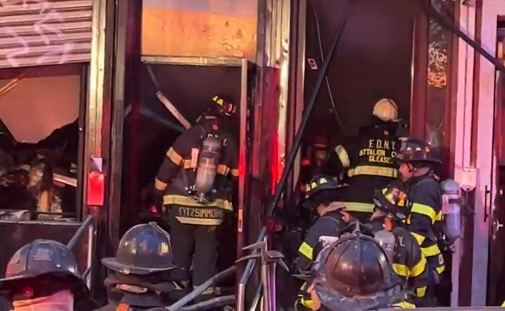 FDNY crews work to control a fire that spread from a main floor restaurant to other parts of the building.