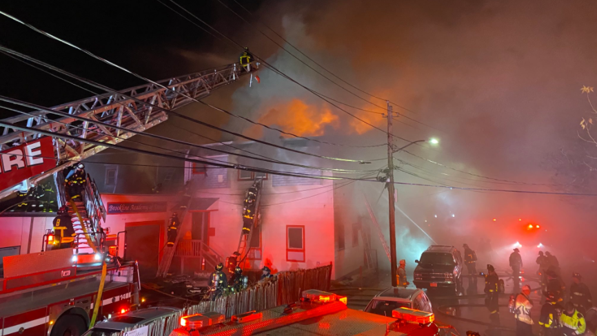 Boston firefighters tackle an eight-alarm fire that burned for several hours in a music school Friday.