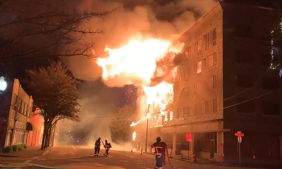 Heavy fire pushes out from a five-story building under construction in Olympia.