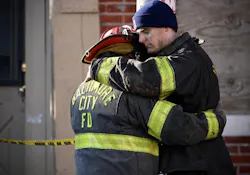 Firefighters hug at the scene of the South Stricker rowhome fire Monday morning. Firefighters hug at the scene of the South Stricker rowhome fire Monday morning.