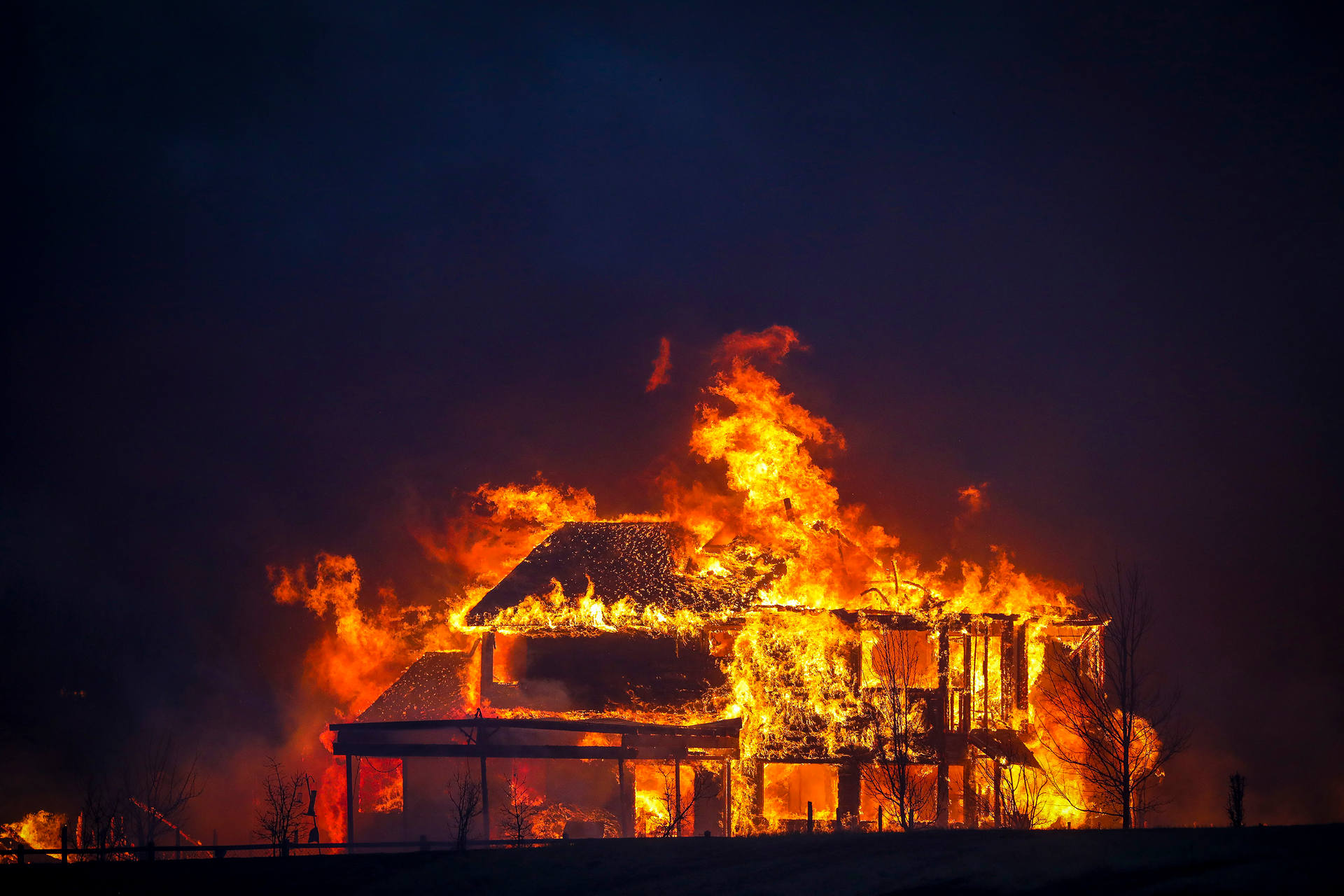 A home burns after a fast-moving wildfire swept through the area in the Centennial Heights neighborhood of Louisville, Colorado on Thursday, Dec. 30, 2021.