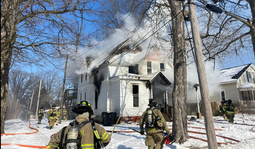 Multiple departments work to control a fast spreading fire in a Bloomington home Monday.