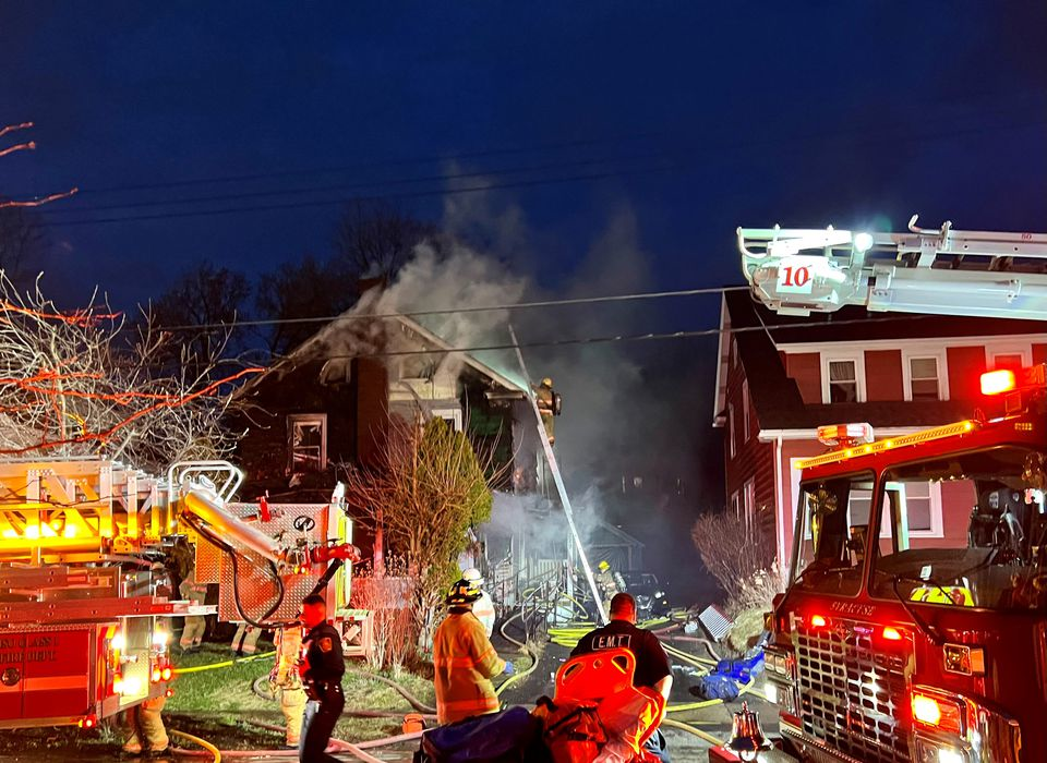 Firefighters work to extinguish a house fire on Fenway Drive on Saturday, March 26, 2022.