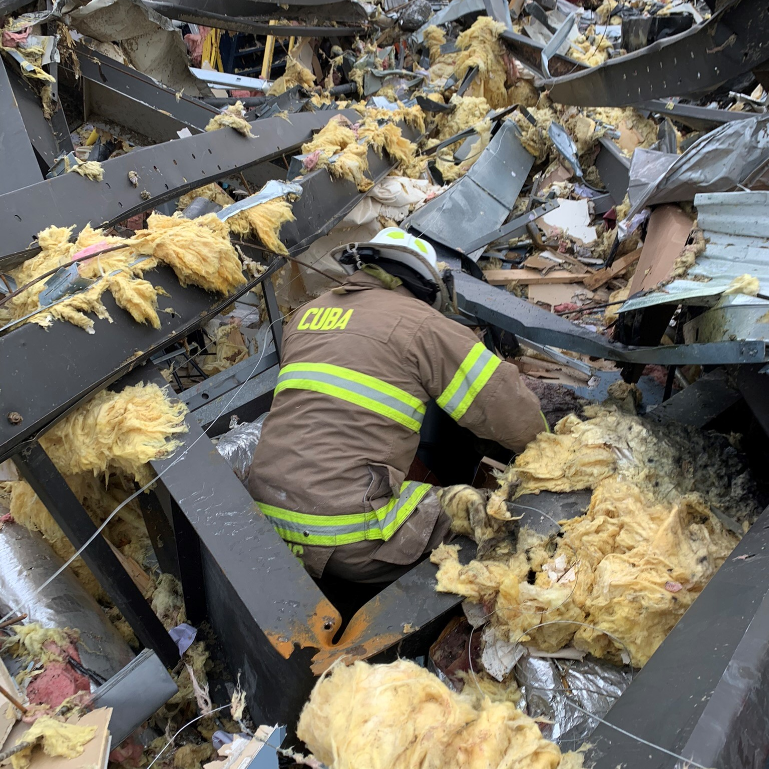 Assistant Chief Chris Travis and Siedel performing search and recovery operations at the candle factory the next morning.