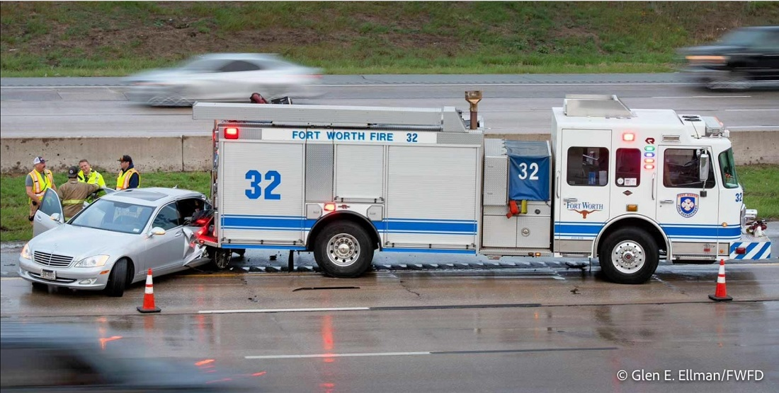 A Fort Worth fire truck sustained rear end damage when a vehicle slid into it on a rain slick highway.