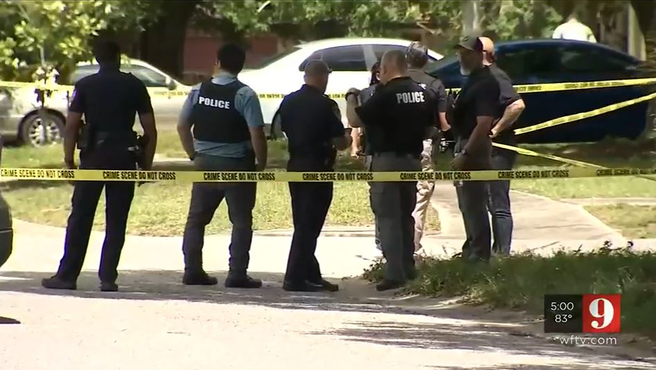 Police work the scene where a woman and man were found dead in an apparatus murder-suicide in Titusville.