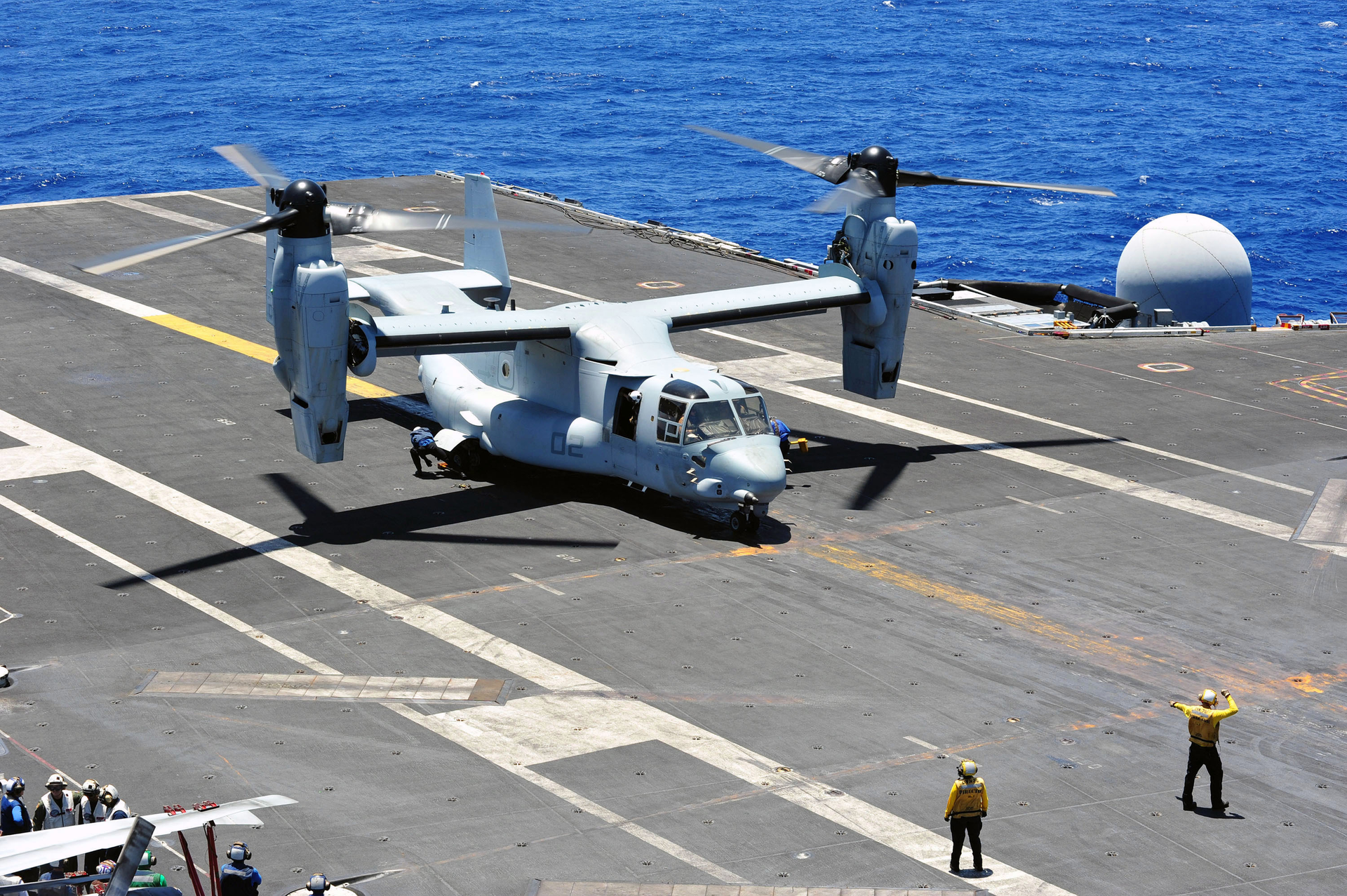 Aviation boatswain's mates chock and chain an MV-22B Osprey in an August 2014 file image.