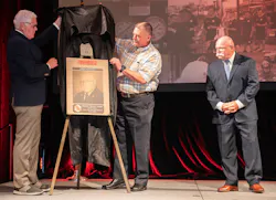 Dr. Denis Onieal (l.) was joined on stage by Firehouse Hall of Famer John J. Salka, Jr. (c.) and together they unveiled Butch Cobb’s Hall of Fame plaque. Dr. Denis Onieal (l.) was joined on stage by Firehouse Hall of Famer John J. Salka, Jr. (c.) and together they unveiled Butch Cobb’s Hall of Fame plaque.