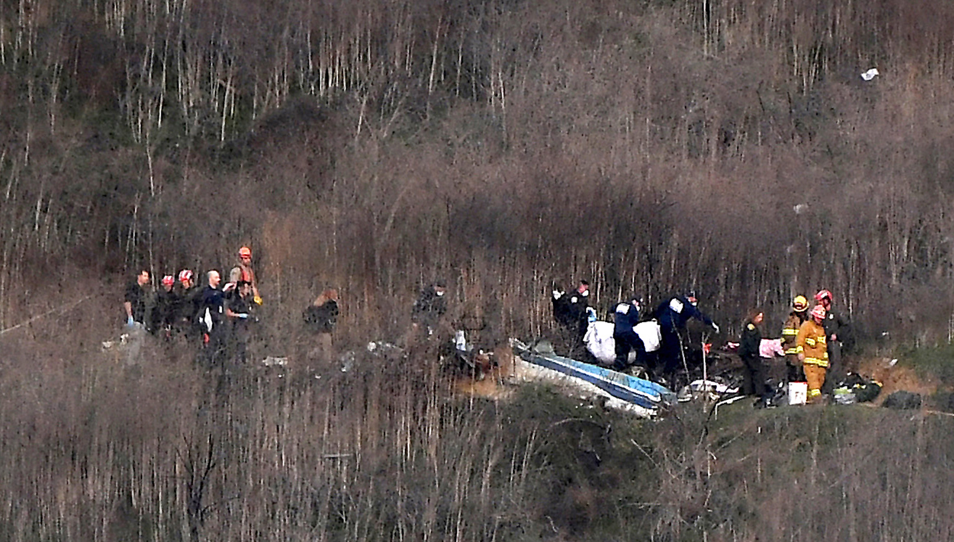 Fire and rescue personnel search the crash site.