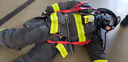 Photo 1: Using webbing and carabiners for firefighter removal begins with attaching the carabiner to the webbing loop and then attaching the carabiner to one of the SCBA shoulder straps above the shoulder. Photo 1: Using webbing and carabiners for firefighter removal begins with attaching the carabiner to the webbing loop and then attaching the carabiner to one of the SCBA shoulder straps above the shoulder.