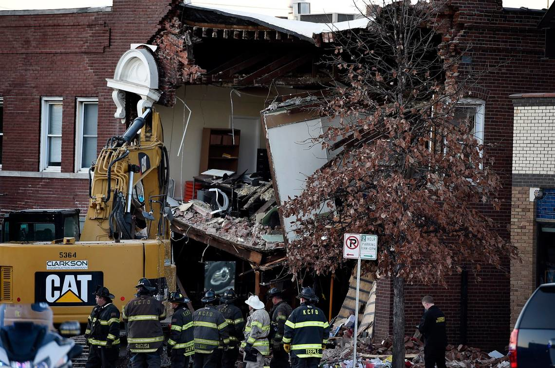 Firefighters and other officials at the scene of the Dec. 15, 2021 crash where a Kansas City Fire Department pumper struck a vehicle and building, leaving three dead.
